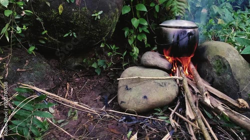 Traditional Outdoor Cooking Rice in a Cast Iron Pot (Kastrol) Over Wood Fire Pit