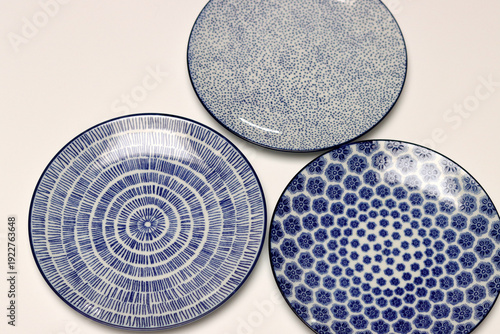 Colorful ceramic plates on blue background. Top view. Copy space.