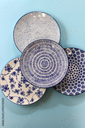 Colorful ceramic plates on blue background. Top view. Copy space.