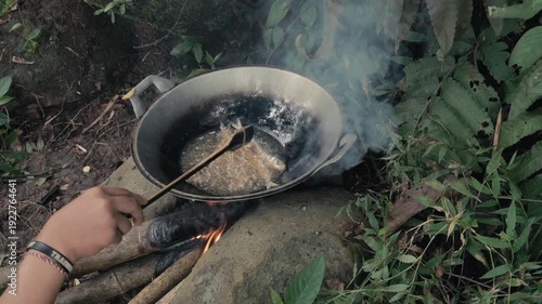 Frying Fresh Fish in a Wok Over a Traditional Open Wood Fire Pit