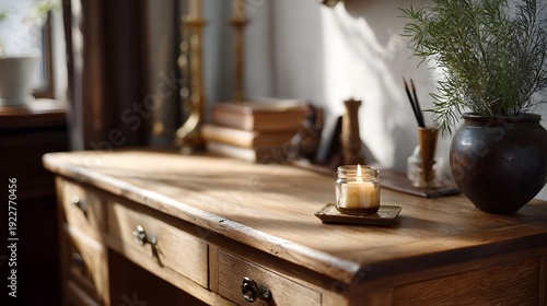 A sunlit vintage wooden desk with a lit candle and decorative accessories creating a warm ambiance