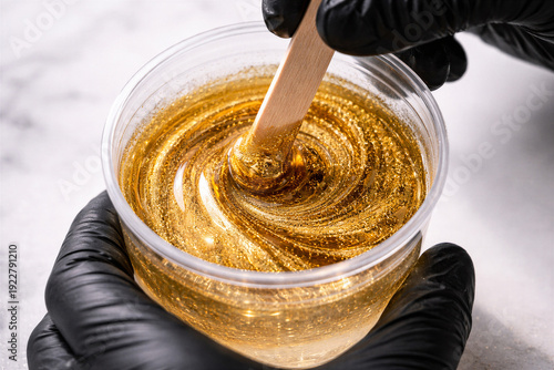 Wallpaper Mural Golden Epoxy Resin Mixture Being Stirred with Wooden Stick in Clear Glass Bowl for Artistic Crafting Projects Torontodigital.ca