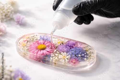 Wallpaper Mural Artisan Carefully Pouring Clear Epoxy Resin Over Colorful Pressed Wildflowers in Oval Silicone Mold for Handmade Jewelry Creation Torontodigital.ca