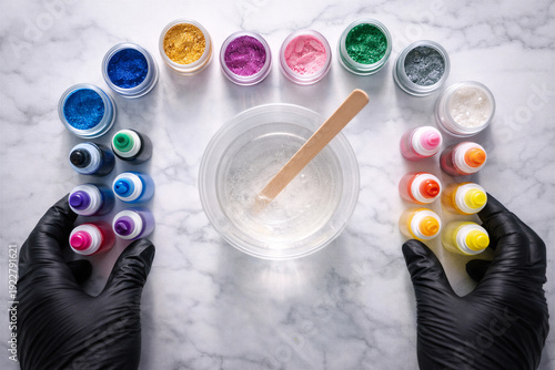 Wallpaper Mural Professional epoxy resin crafting workspace featuring rainbow array of metallic and liquid pigments, clear mixing bowl with wooden stirrer, and protective gloves on elegant marble background Torontodigital.ca