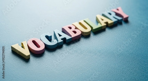 Colorful wooden letters on a blue surface spell out 