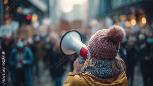 Woman Using Megaphone in Crowded Urban Protest Scene