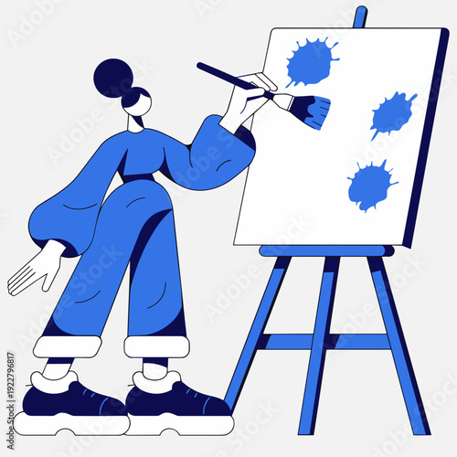 Young woman painting on canvas with blue paint and brush  