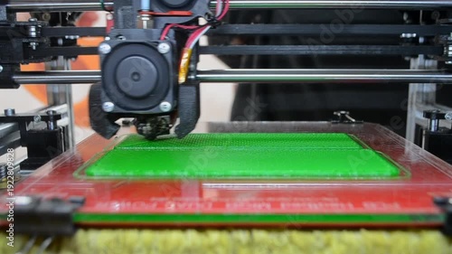 3D printer. 3D printer printing object close-up. 3D printer printing model green color. Working 3D printer. Concept printing technology. New modern additive progressive technology. FDM technologies