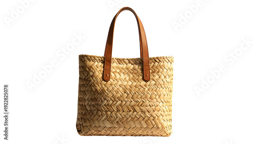 A rectangular woven straw tote bag with brown leather handles, isolated on black
