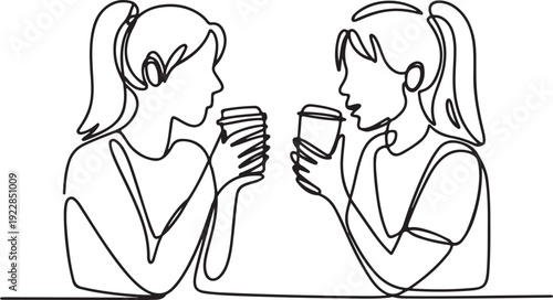 Two women toasting with coffee cups in a relaxed social setting