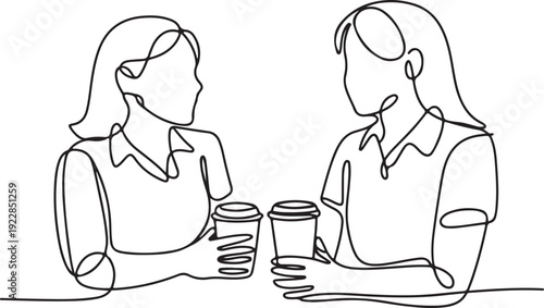 Two women having a conversation over coffee cups in a relaxed setting