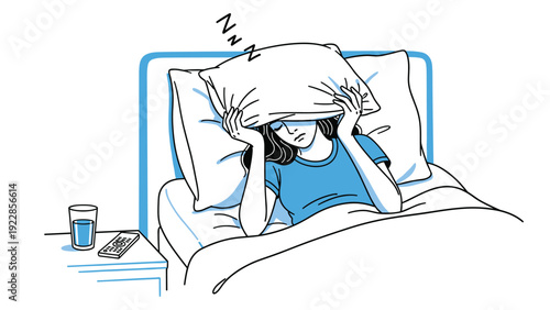 Tired woman lying in bed trying to sleep while covering her head with a pillow to block out noise or bright morning light.