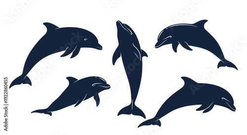 Set of dark blue dolphin silhouettes showing various swimming and jumping poses isolated on a white background for marine themes.