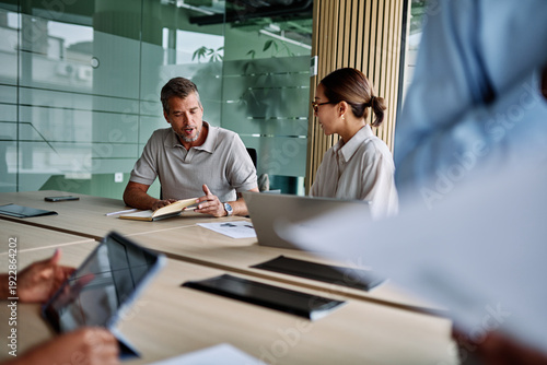 Wallpaper Mural Portrait of young businesswoman and mid aged businessman having a meeting or presentation and seminar in the office Torontodigital.ca