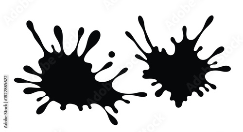 Abstract black ink splatters forming dynamic irregular shapes