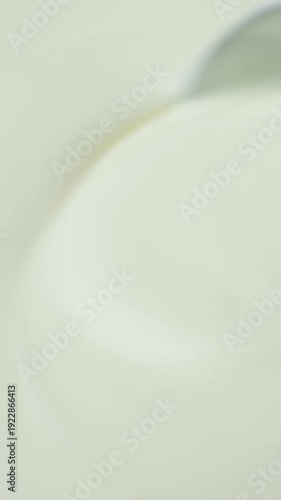 Close-up of a Metal Spoon Stirring Fresh Homemade Greek Yogurt