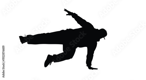 Silhouette of a person dynamically posing in a breakdancing position