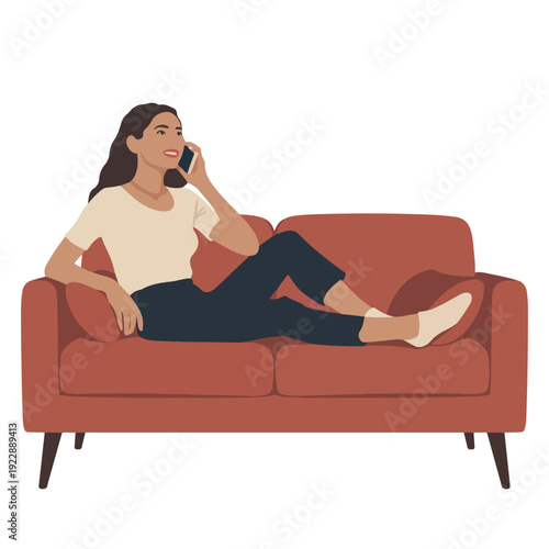 A woman sitting on a couch and talking on her phone in a relaxed pose
