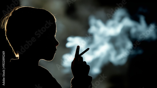 Silhouette of a young child holding a cigarette with smoke