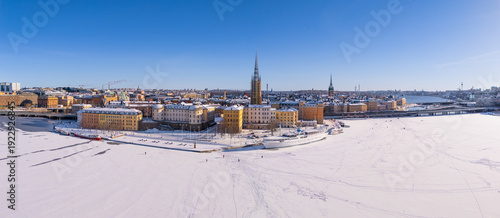 Canvastavla Wintry Stockholm old town, with ice and snow, and people walking on the lake, cl