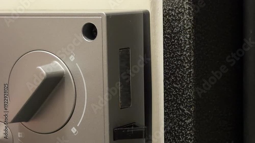 A silver electronic lock moves its sturdy metal bolt to secure or open a door. The clean lines and mechanical action provide a reassuring sense of safety and modern protection.