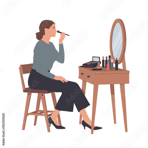 A woman applies makeup in front of a vanity with a mirror and various cosmetics