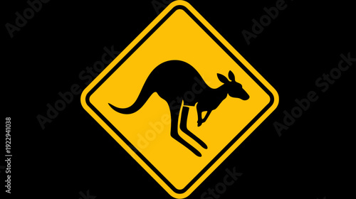 Road warning sign for kangaroos, yellow diamond with black jumping marsupial silhouette, traffic safety symbol isolated on black