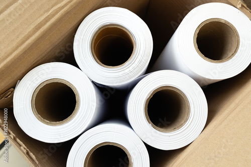 Top view of large white paper rolls (A1 size) packed inside a cardboard shipping box