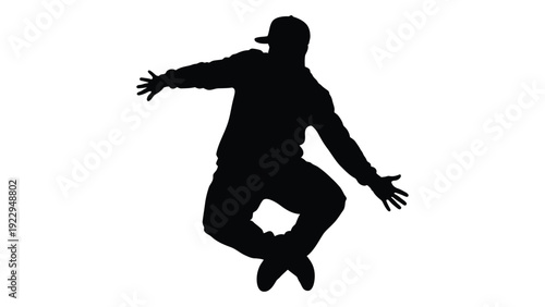 Silhouette of a person in mid air dynamically posed with arms outstretched