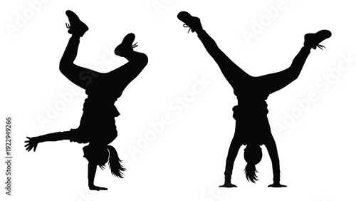Two silhouetted figures performing handstands capturing dynamic movement and athletic pose