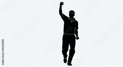 Confident man celebrating success with raised fist in modern silhouette
