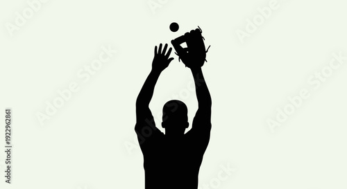 Man in silhouette catching ball with baseball glove