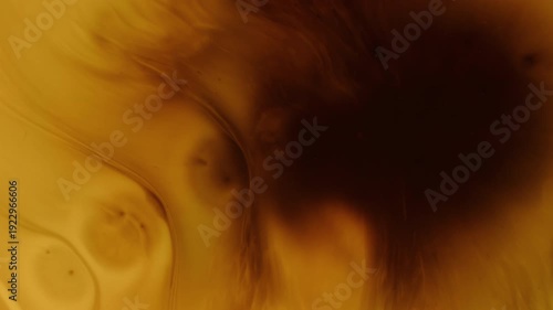 Dye blot. Wet splatter. Black paint spread orange brown water abstract background. Grunge dripping art defocused messy color flow.