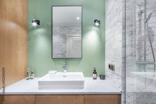 Billede på lærred A bathroom is set up with a square sink on a light counter