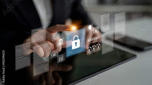 Принти на полотні A business professional interacts with a tablet showcasing digital security visuals, emphasizing data protection and cybersecurity in a modern work environment