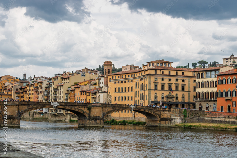 Fototapeta premium Famous historic Ponte Vecchio bridge and old buildings along the Arno river in Florence Italy