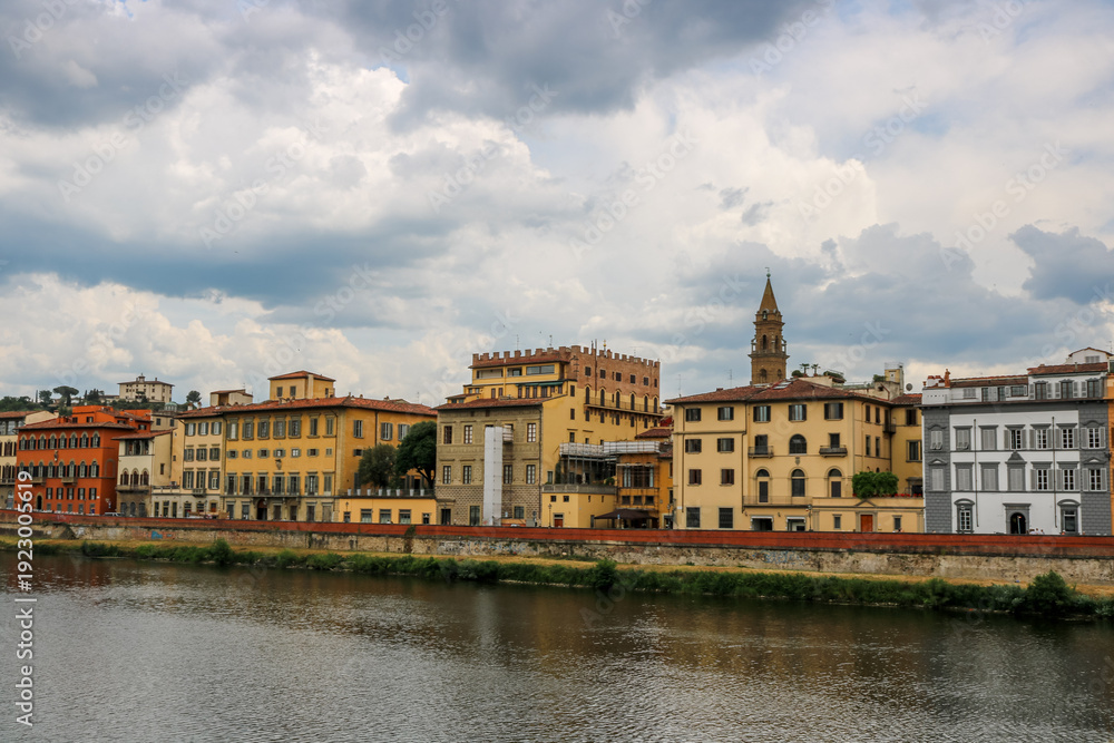 Fototapeta premium Famous historic Ponte Vecchio bridge and old buildings along the Arno river in Florence Italy