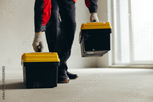 Hand Lifting Tool Case By Handle Above Concrete Floor.