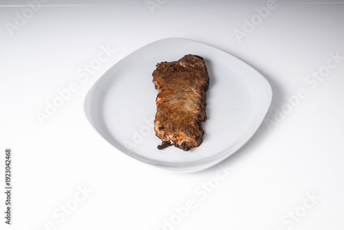 Photos Single grilled flank steak displaying delicious brown crust, ready for eating as