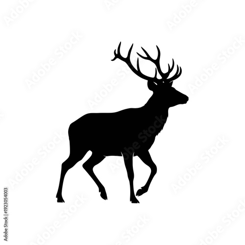 Silhouette of a majestic stag with large antlers walking.