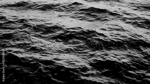 Textured dark ocean waves captured in a high contrast monochrome abstract pattern showcasing dynamic motion