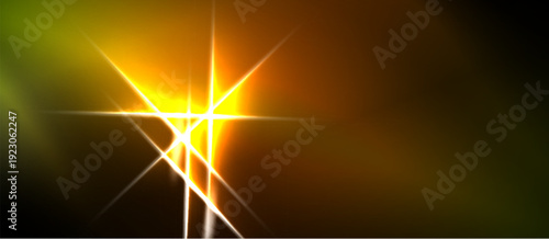Bright light flare dominates image. Orange, yellow hues blend into darkness. Rays emanate from central point, creating dramatic effect.