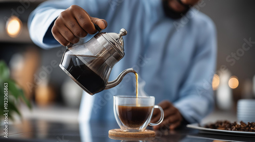 Faceless person pouring hot water for herbal tea during Suhoor or Iftar, preparing warm beverage for Ramadan, Islamic fasting ritual, with copy space