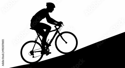 Silhouette of a cyclist riding a road bike up a steep hill.