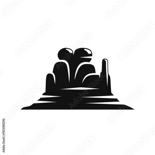 Silhouette of a geyser erupting in a desert landscape.