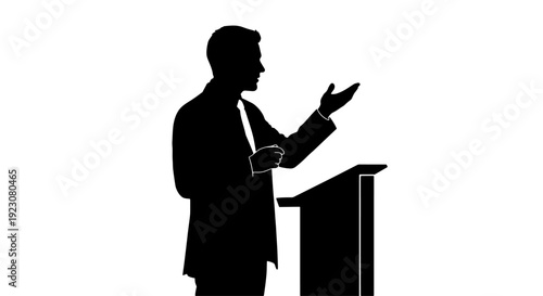 Silhouette of a man speaking at a podium, gesturing with his hand during a presentation or public address.