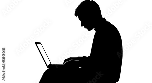 A silhouette of a person working intently on a laptop against a bright white background, depicting focus and digital engagement.