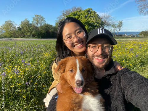 Outdoor family portrait with a mixed race couple and their dog