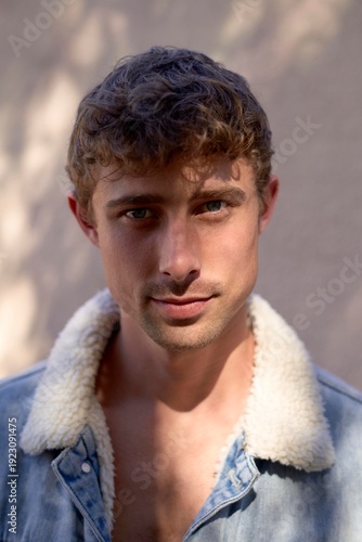 Young Man With Tousled Hair in Denim Jacket and Natural Light