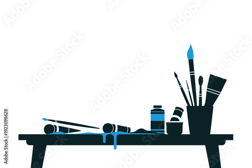 Artist's workspace with paintbrushes and supplies on a table
